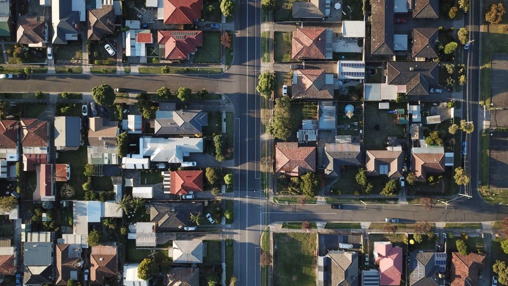 Above view of residential houses showing their boundaries, nearby roads, and neighbouring properties.