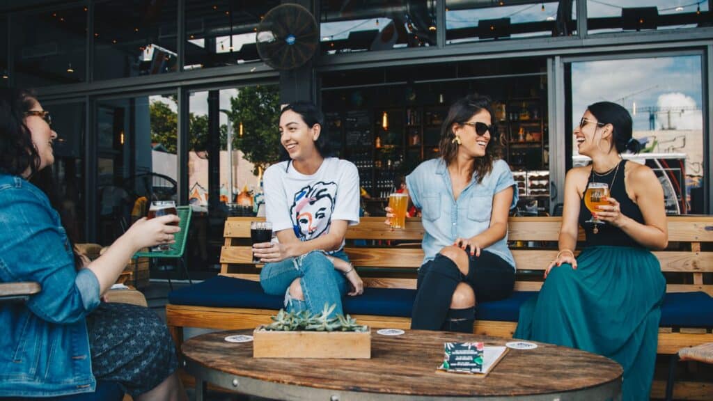 Patrons drinking outside a pub.