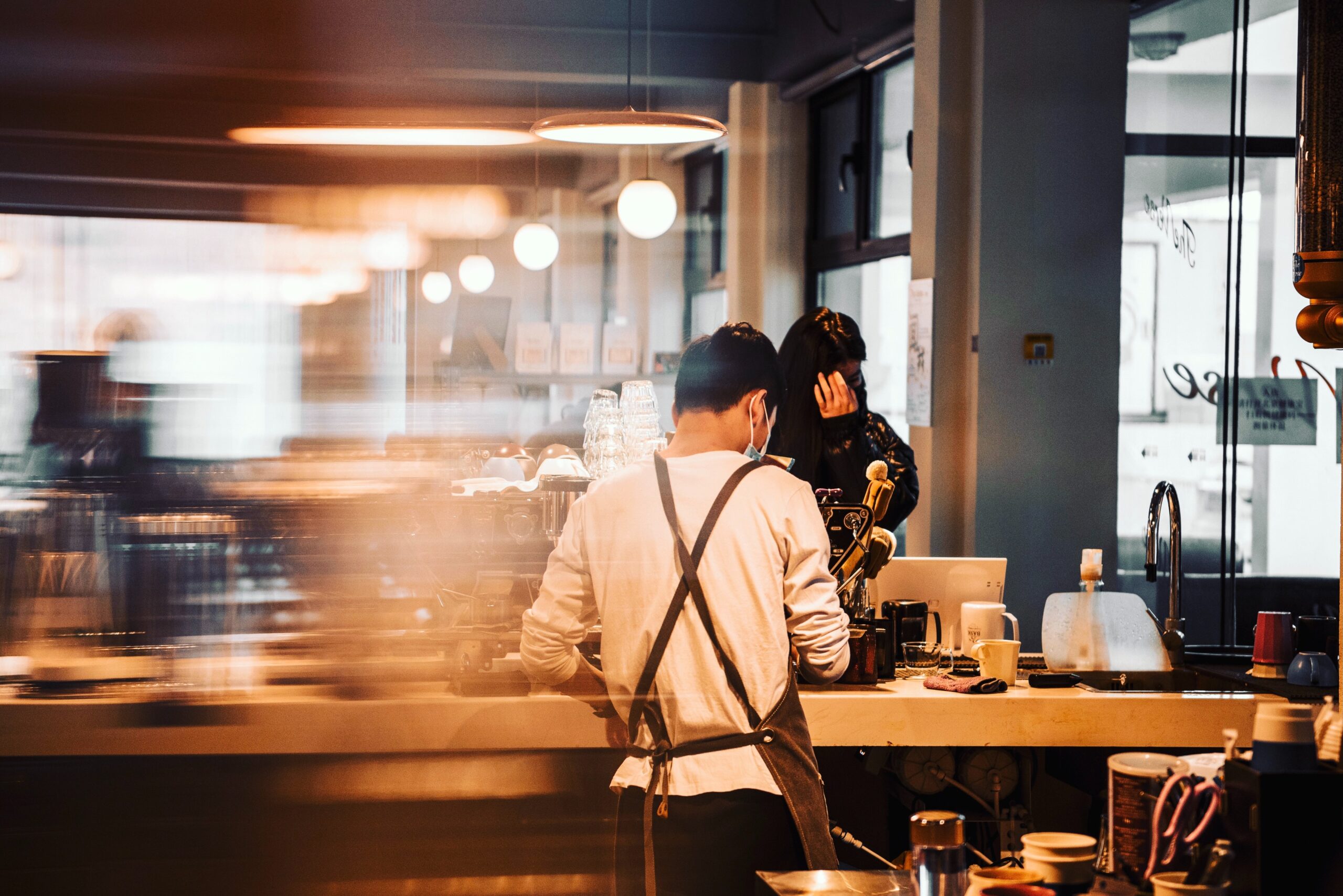 Fast-paced hospitality environment showing the owner contemplating a business dispute.