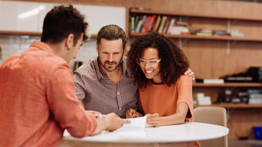 Home buyers reviewing their building contract with the builder.