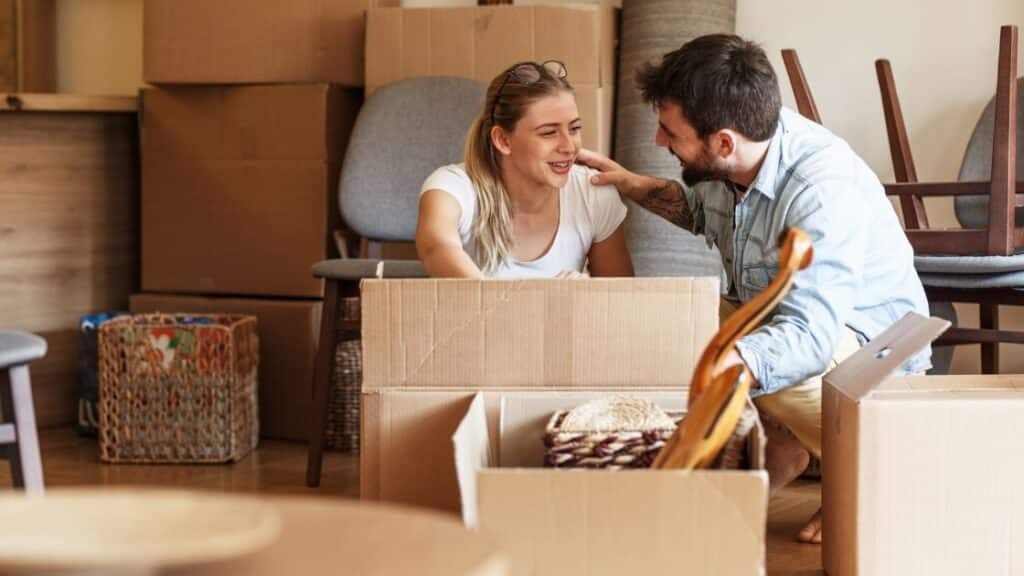 Woman and man unpacking boxes at home following a caveat registration.