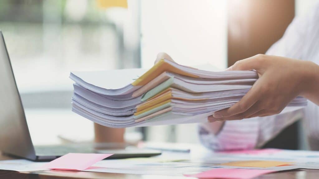 Legal documents in a pile with post-it notes.