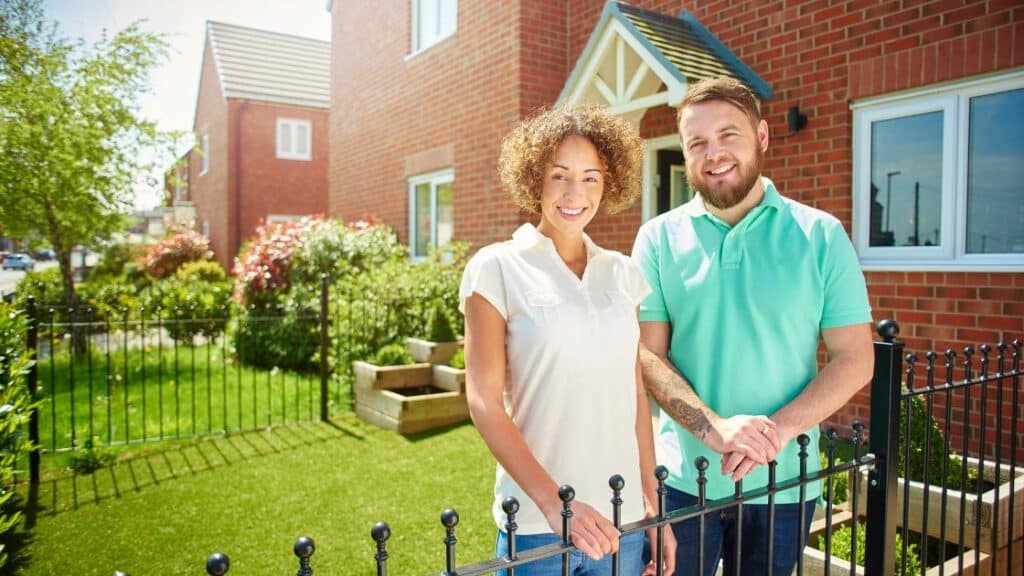 Two people standing on their partitioned property.