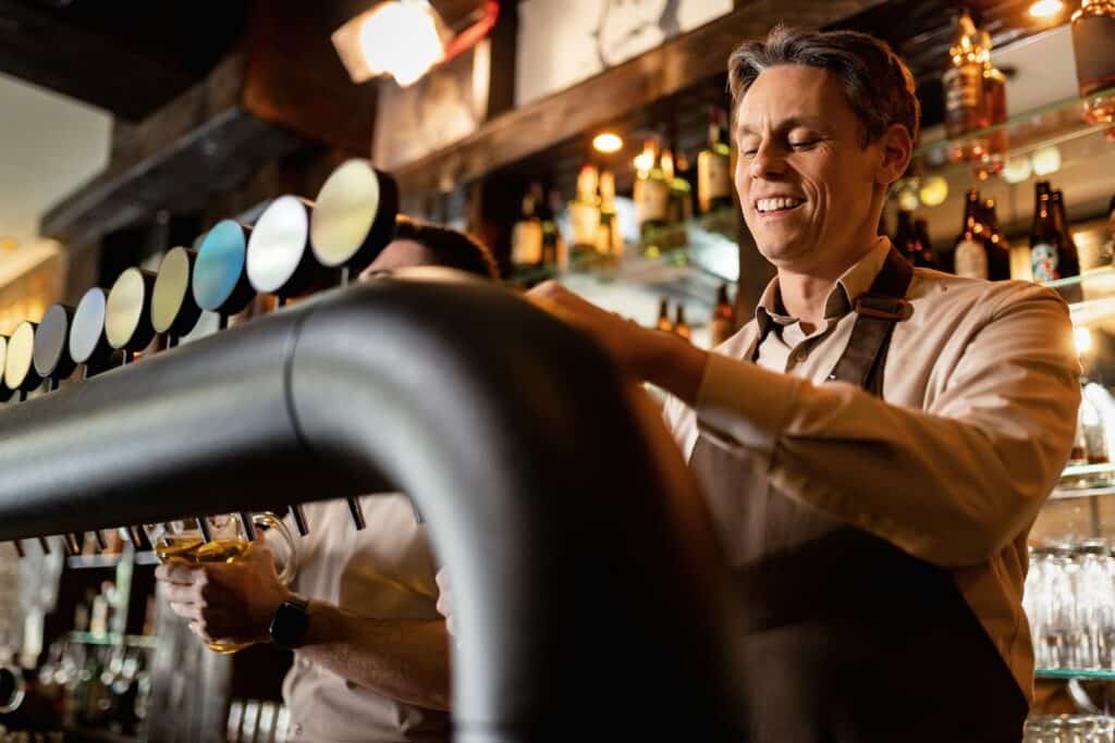 Bartender pouring beer from the tap.