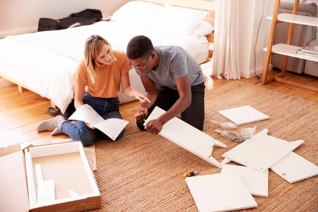 First home buyers assembling furniture in their new home, following recent changes to stamp duty in NSW.