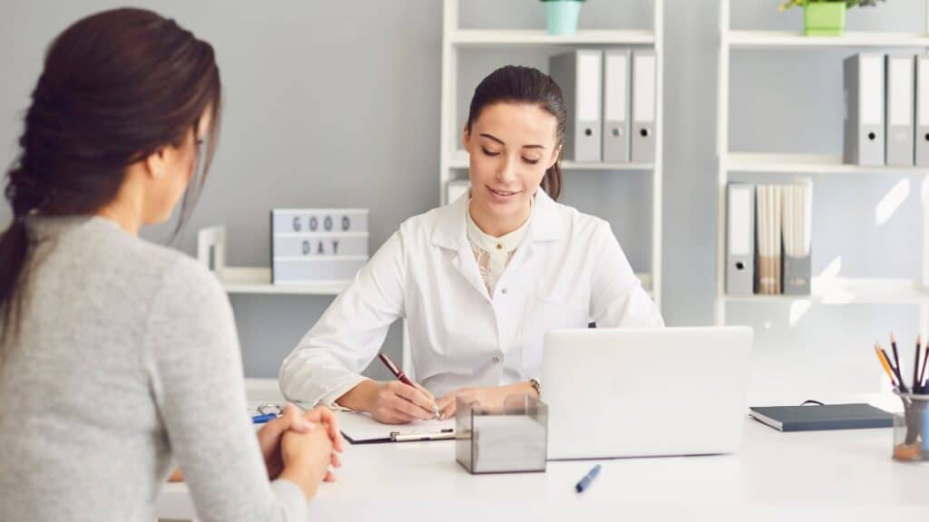 Female doctor and patient discussing healthcare directive information.