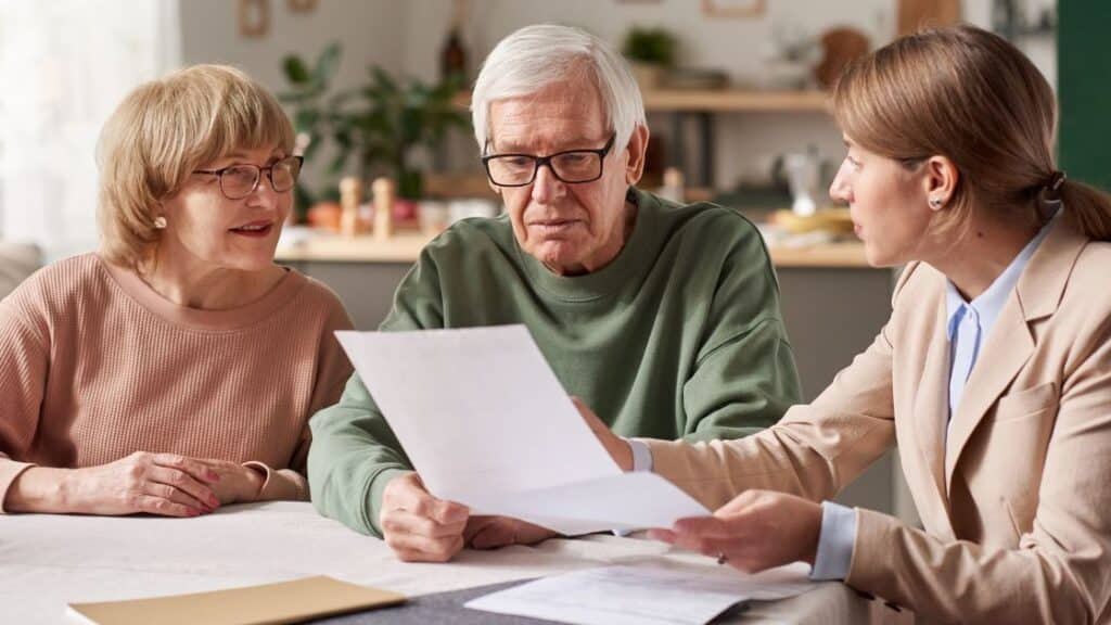 Australian elderly couple speaking to a lawyer about their wills and estate planning.