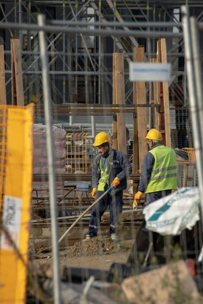 Security of Payments Act. Two workers wearing high vis clothing on a construction site.