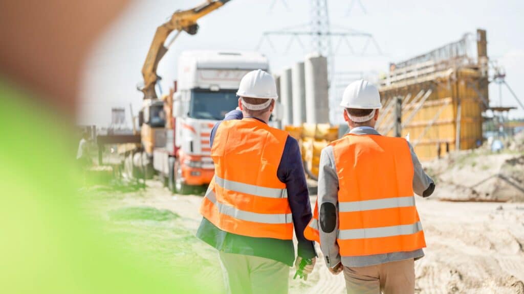 Construction site managers on-site discussing a contractual dispute.