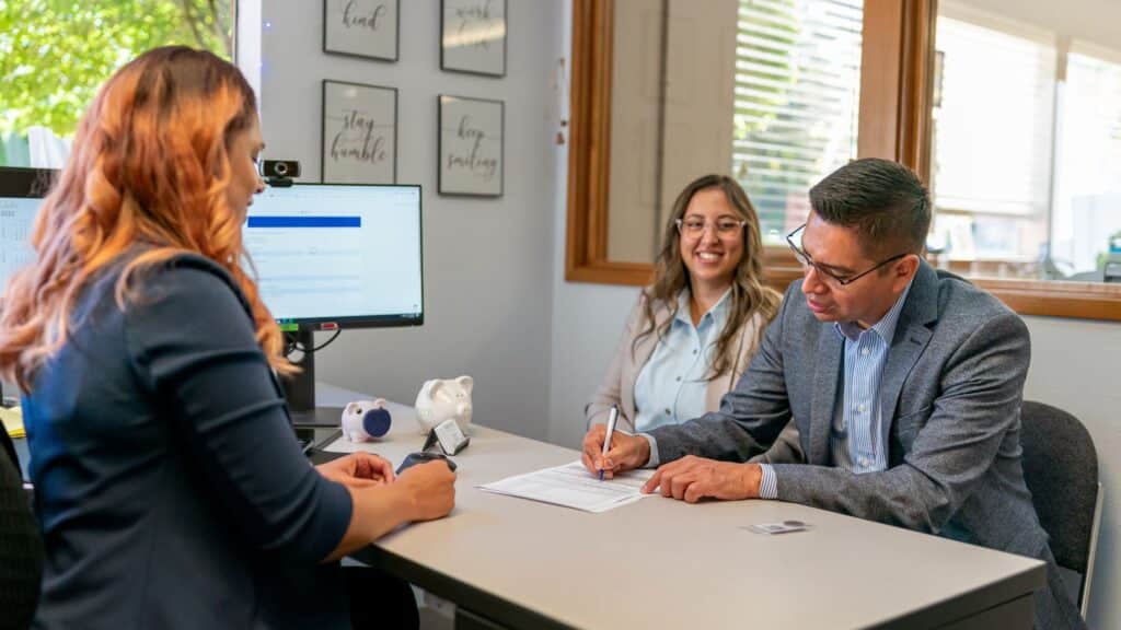 Man and woman creating a trust with a lawyer.