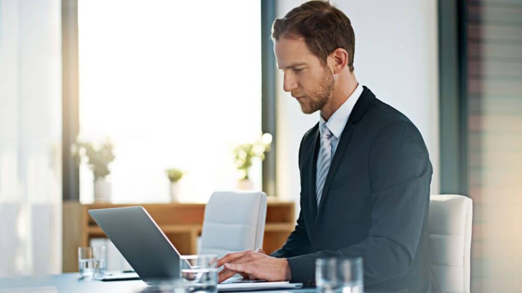 Wollongong commercial property lawyer conducting his due diligence checks on his laptop.